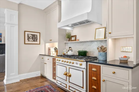 a kitchen with stainless steel appliances granite countertop a stove sink and cabinets