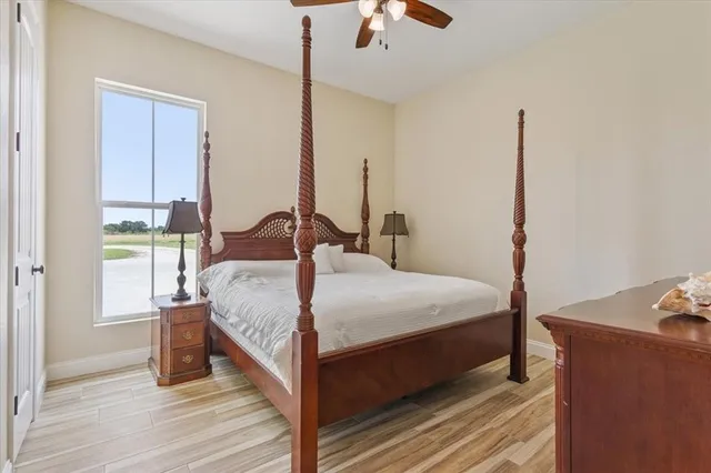 a view of a room with wooden floor lounge chair and windows