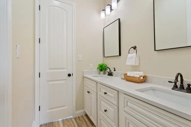 a view of a hallway with wooden floor and cabinet