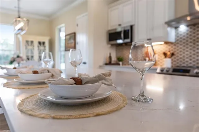 a kitchen with a sink and a stove with white countertops