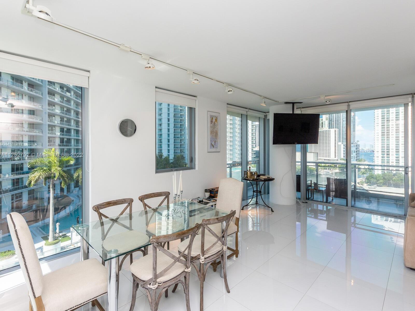 92 Southwest 3rd Street, Unit 1510 Miami, FL 33130 - Photo 13 of 90 a dining room with furniture and large windows