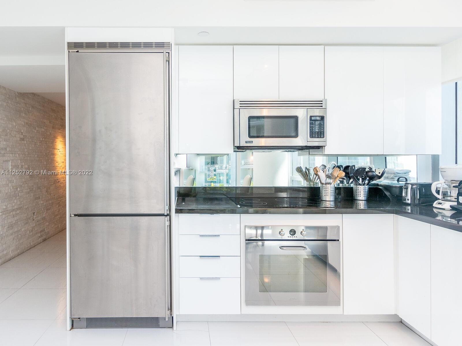 92 Southwest 3rd Street, Unit 1510 Miami, FL 33130 - Photo 18 of 90 a kitchen with stainless steel appliances granite countertop a refrigerator and a stove