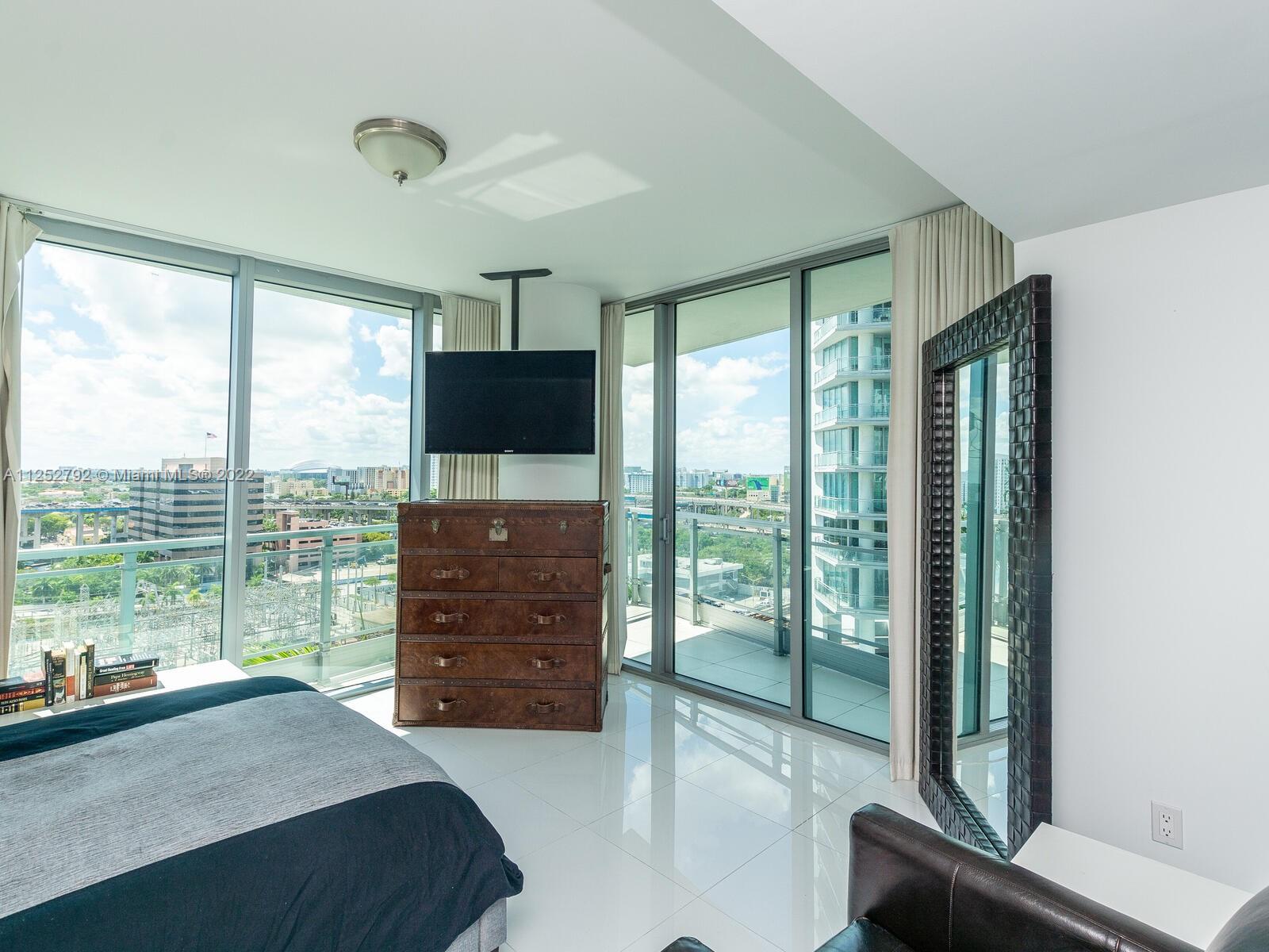 92 Southwest 3rd Street, Unit 1510 Miami, FL 33130 - Photo 24 of 90 a bedroom with a bed and large window