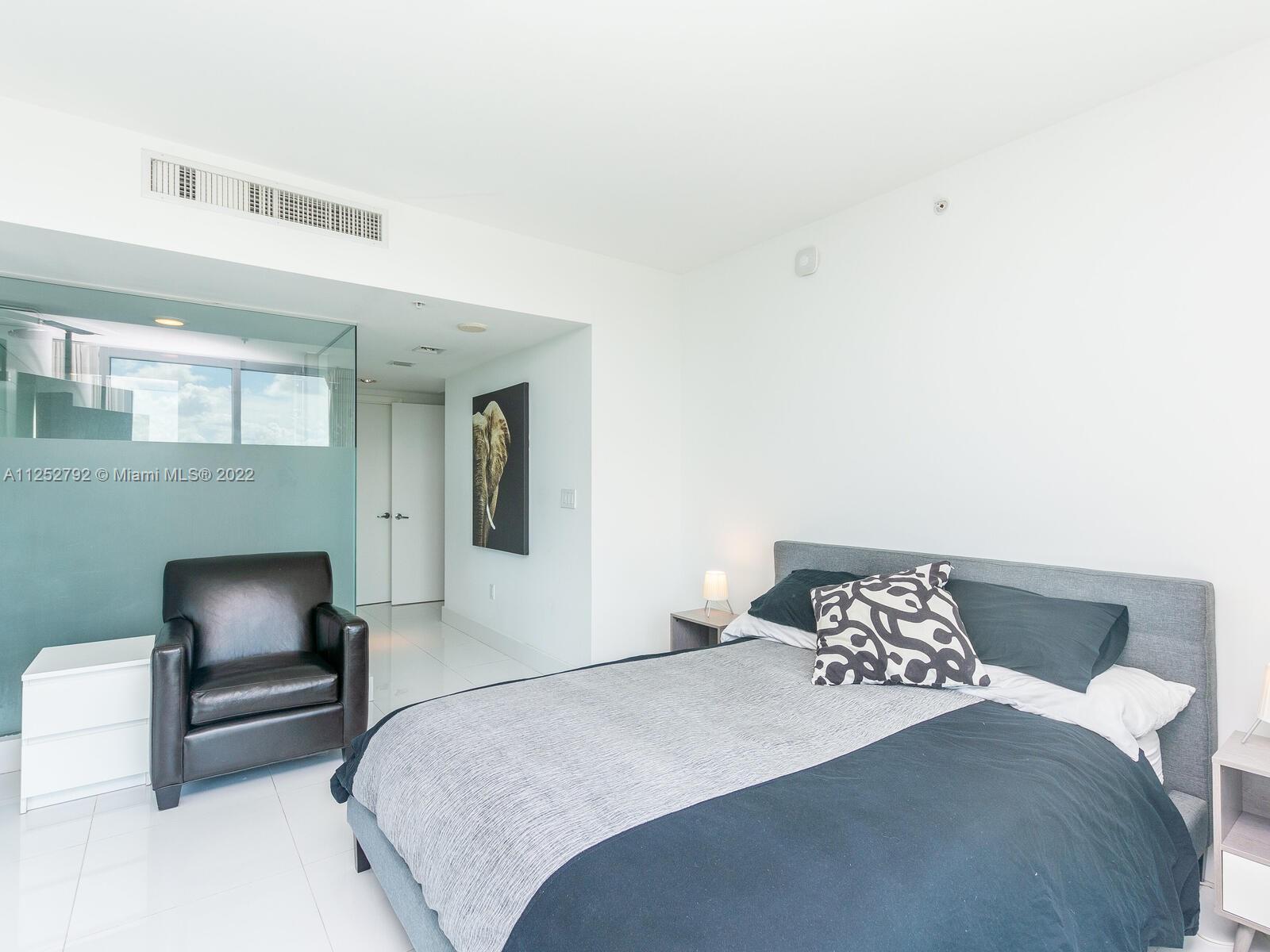 92 Southwest 3rd Street, Unit 1510 Miami, FL 33130 - Photo 25 of 90 a bedroom with a bed and a chair
