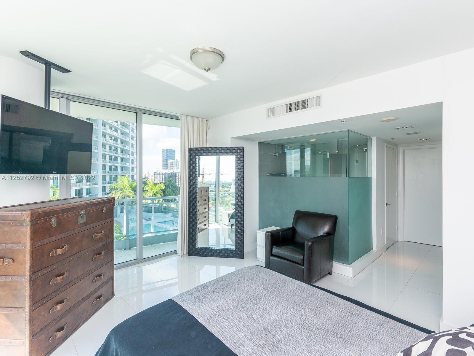 92 Southwest 3rd Street, Unit 1510 Miami, FL 33130 - Photo 26 of 90 a living room with furniture and a flat screen tv