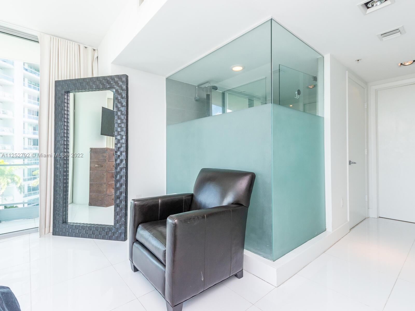 92 Southwest 3rd Street, Unit 1510 Miami, FL 33130 - Photo 27 of 90 a living room with furniture and a large mirror