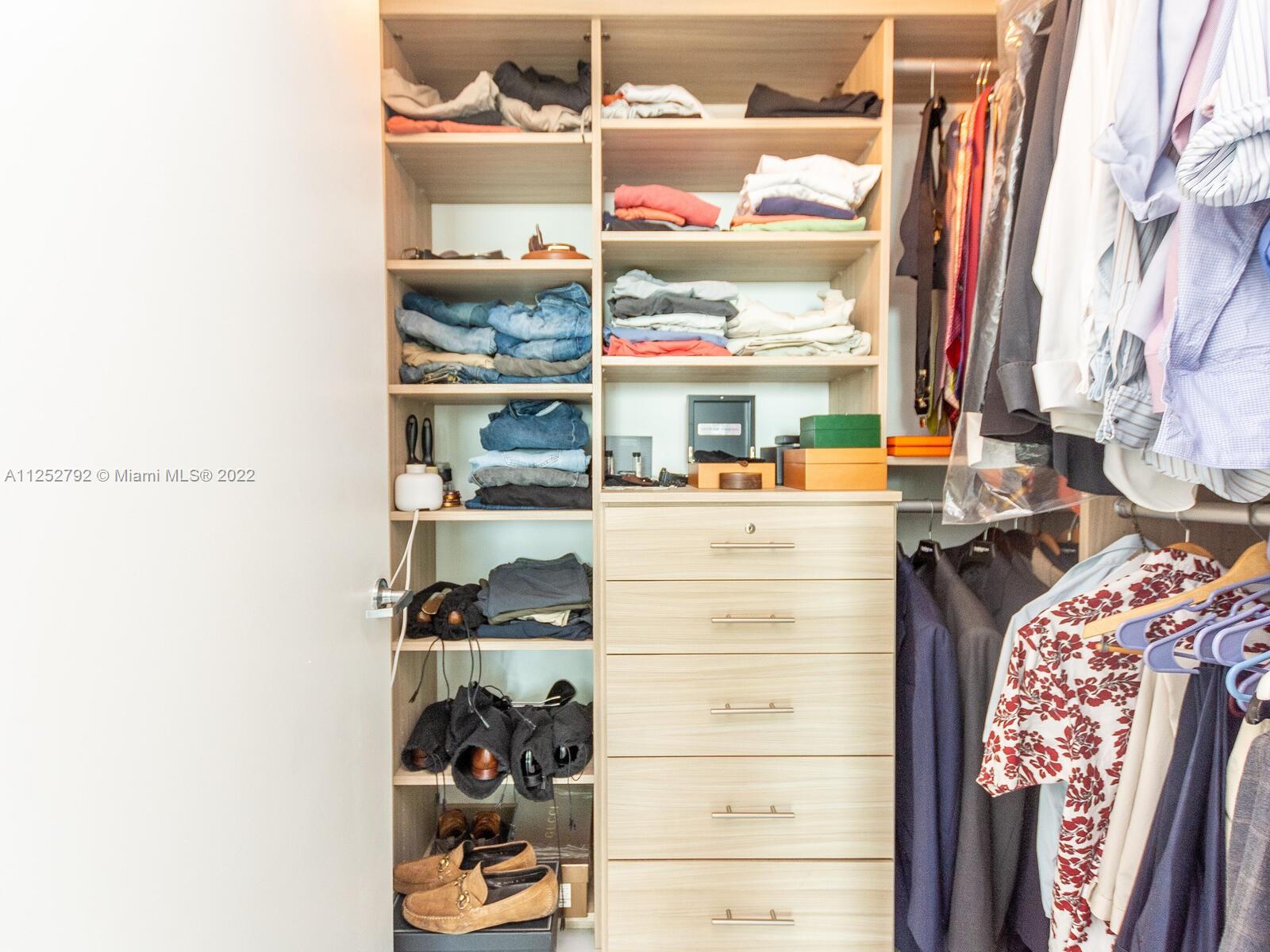 92 Southwest 3rd Street, Unit 1510 Miami, FL 33130 - Photo 31 of 90 a view of walk in closet with clothes and shoes