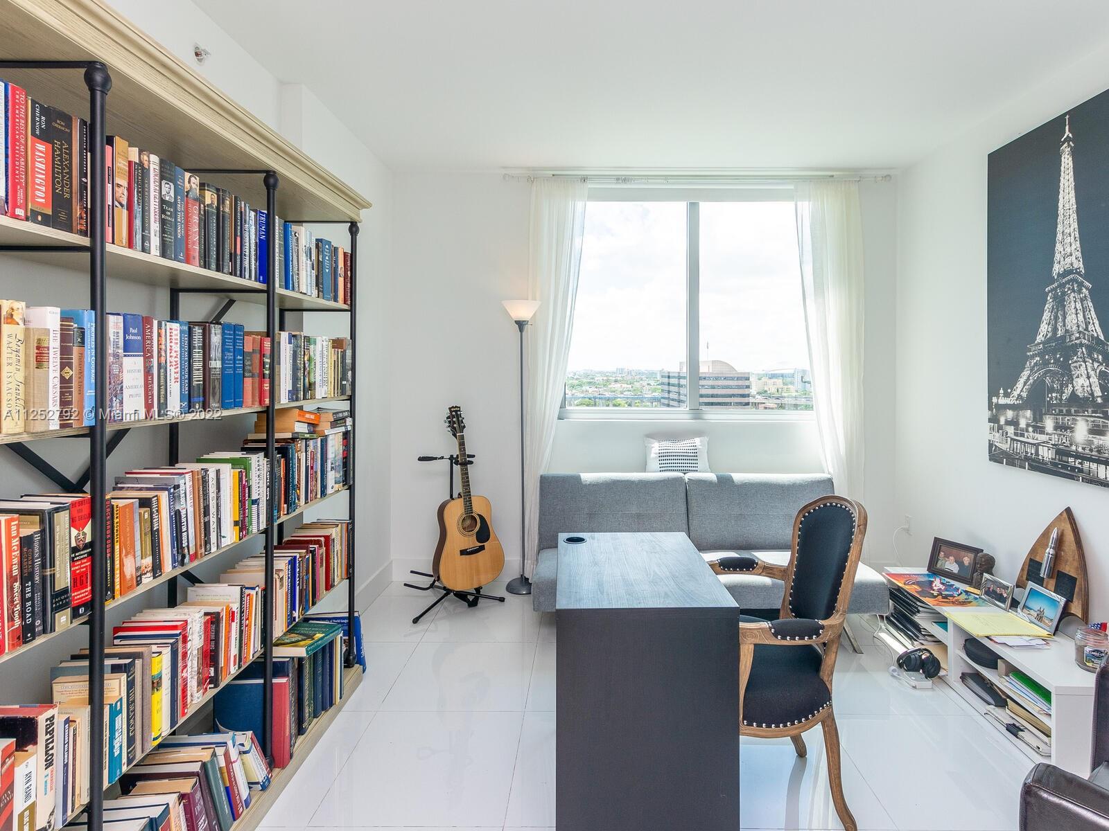 92 Southwest 3rd Street, Unit 1510 Miami, FL 33130 - Photo 35 of 90 a view of a workspace with furniture and a bookshelf
