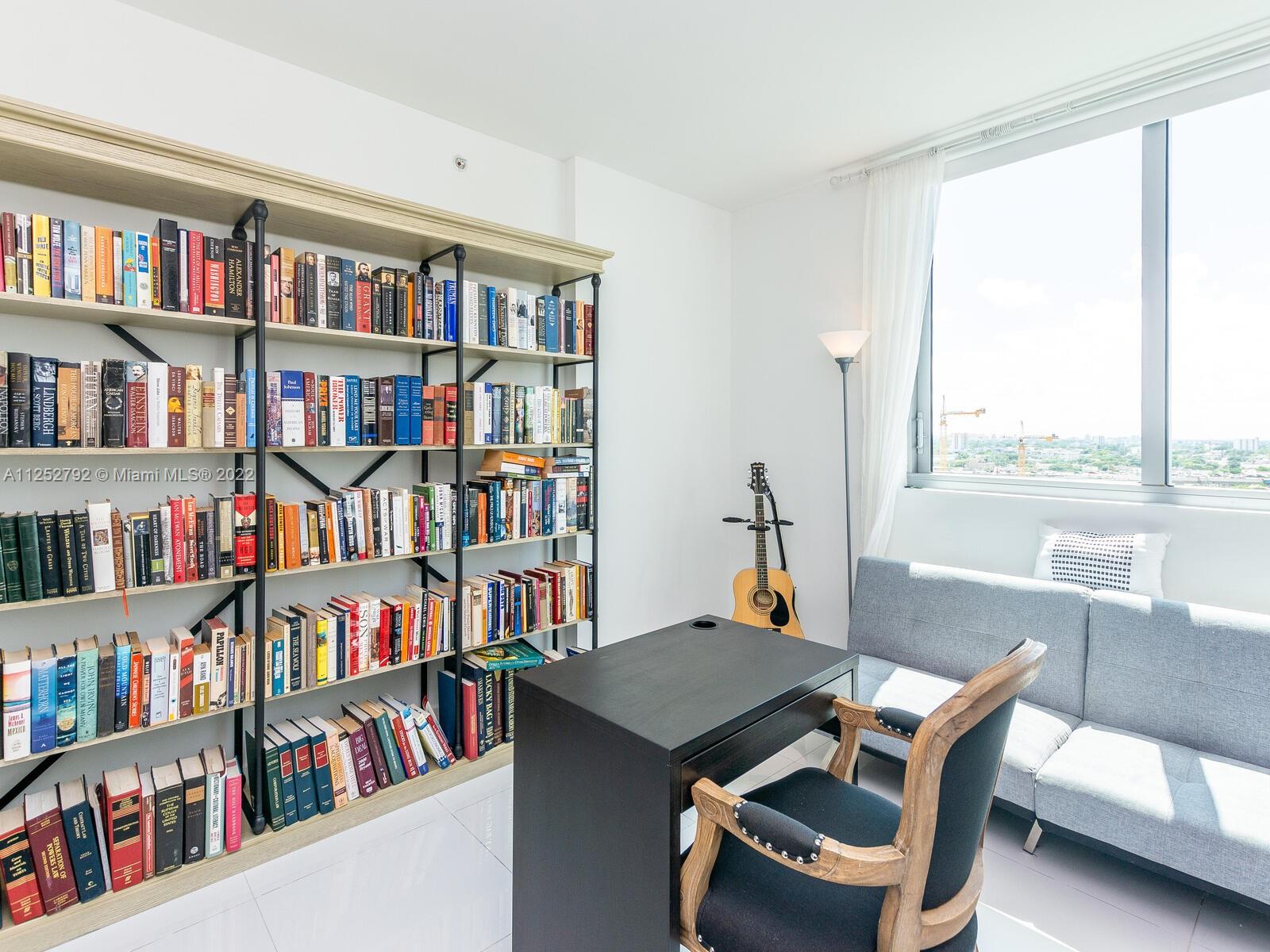 92 Southwest 3rd Street, Unit 1510 Miami, FL 33130 - Photo 36 of 90 a view of a workspace with furniture and a bookshelf
