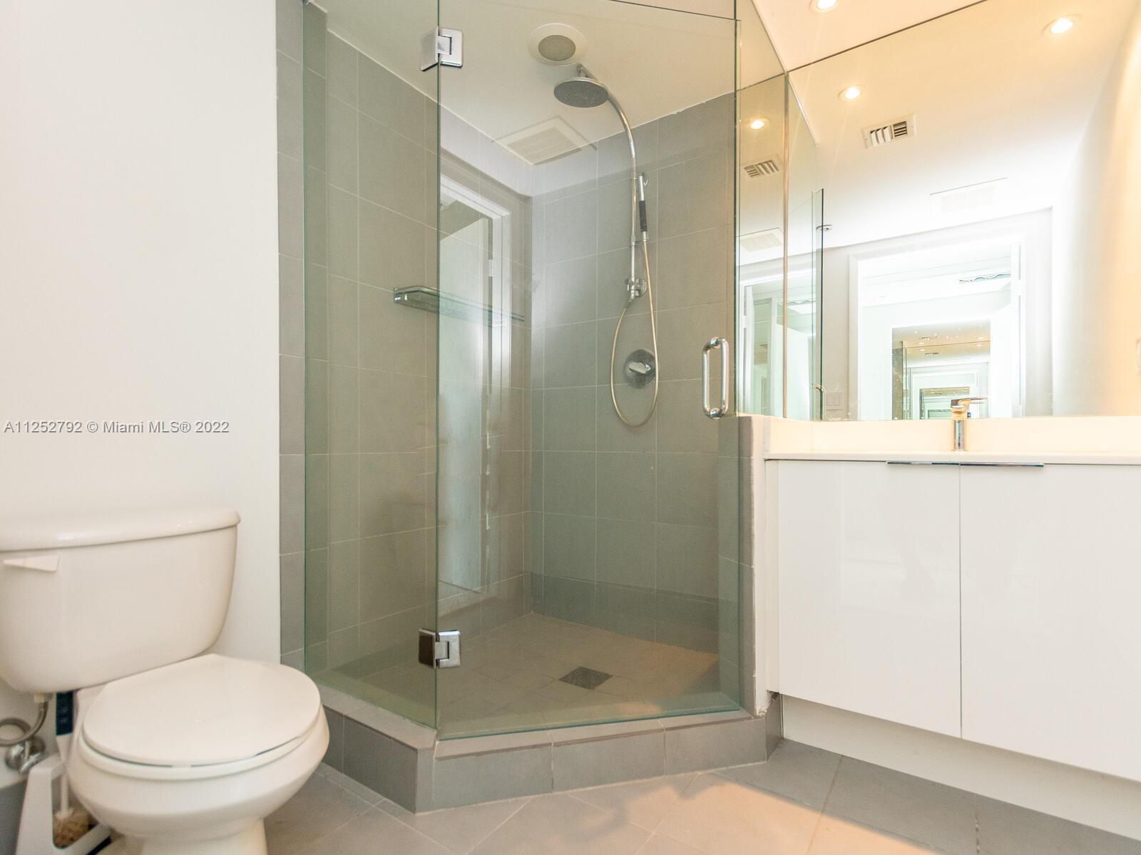92 Southwest 3rd Street, Unit 1510 Miami, FL 33130 - Photo 38 of 90 a bathroom with a shower a toilet and a sink