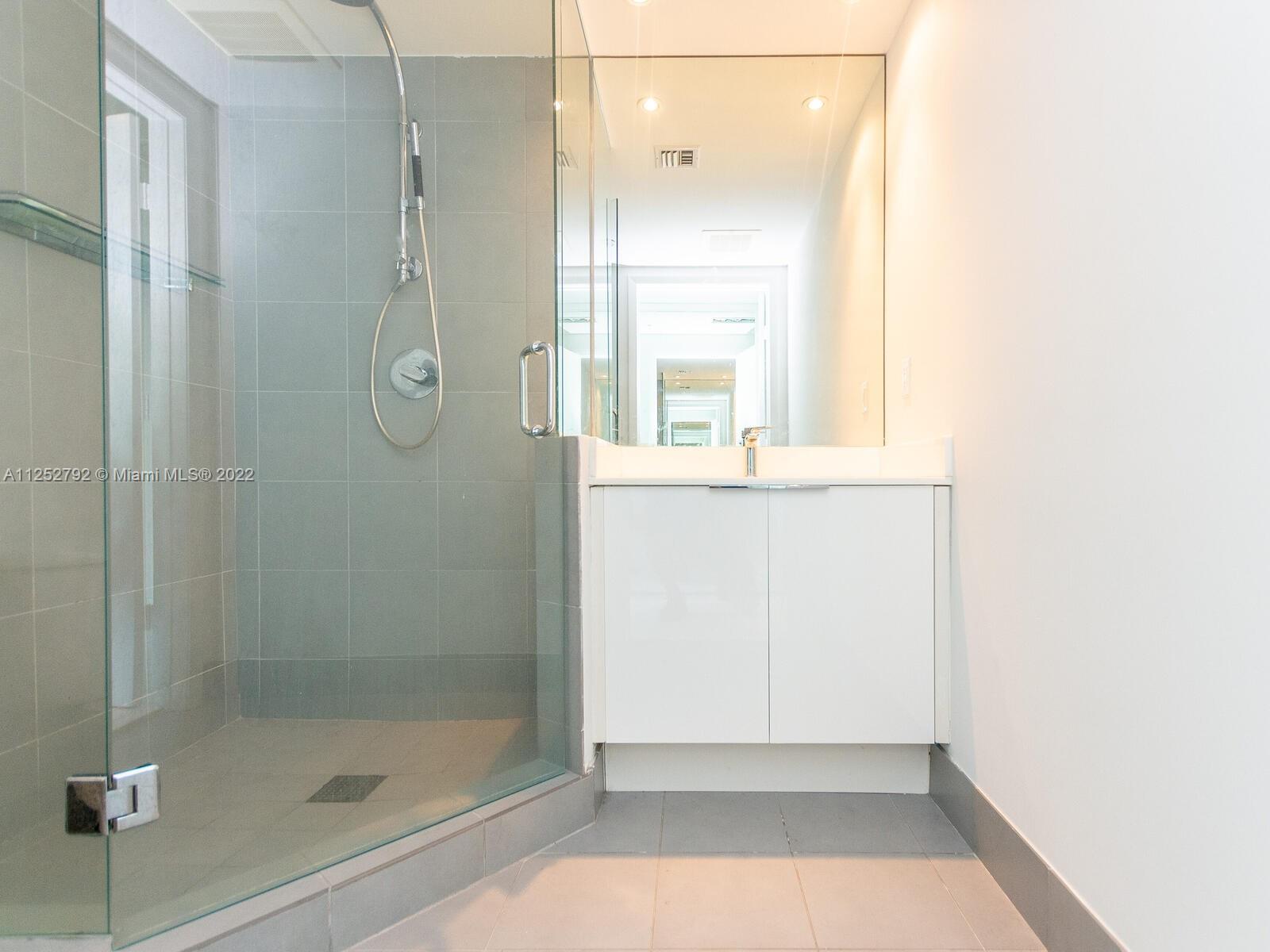 92 Southwest 3rd Street, Unit 1510 Miami, FL 33130 - Photo 39 of 90 a bathroom with a glass shower door