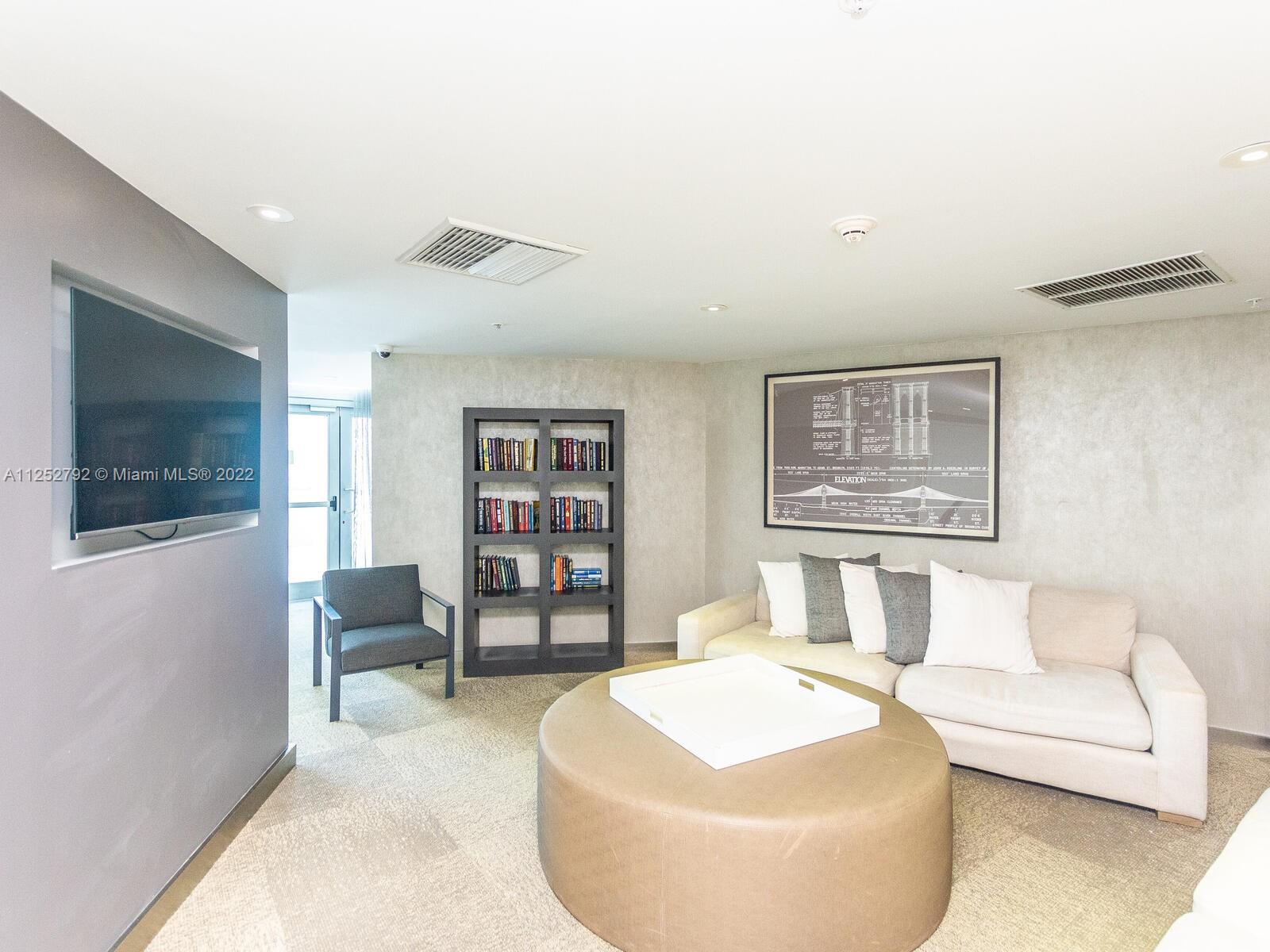 92 Southwest 3rd Street, Unit 1510 Miami, FL 33130 - Photo 58 of 90 a living room with furniture and a flat screen tv