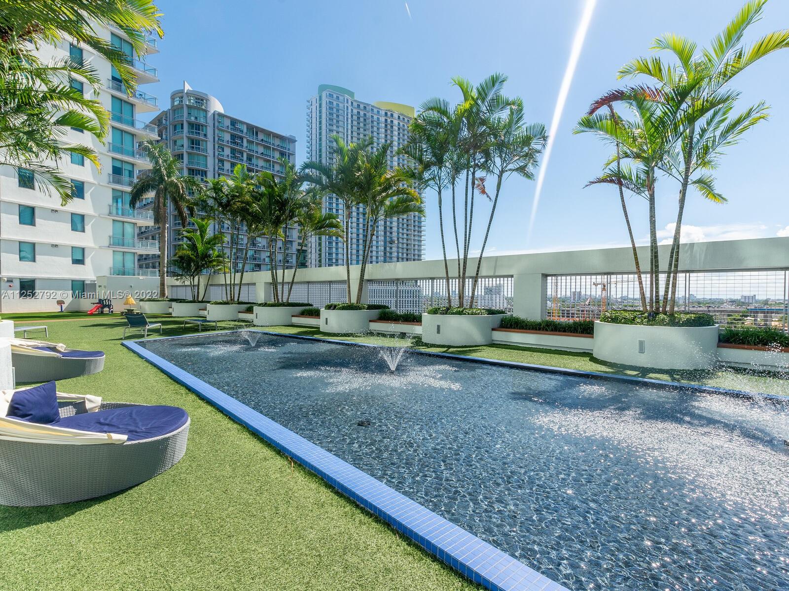 92 Southwest 3rd Street, Unit 1510 Miami, FL 33130 - Photo 64 of 90 a view of a backyard with a tub and palm trees