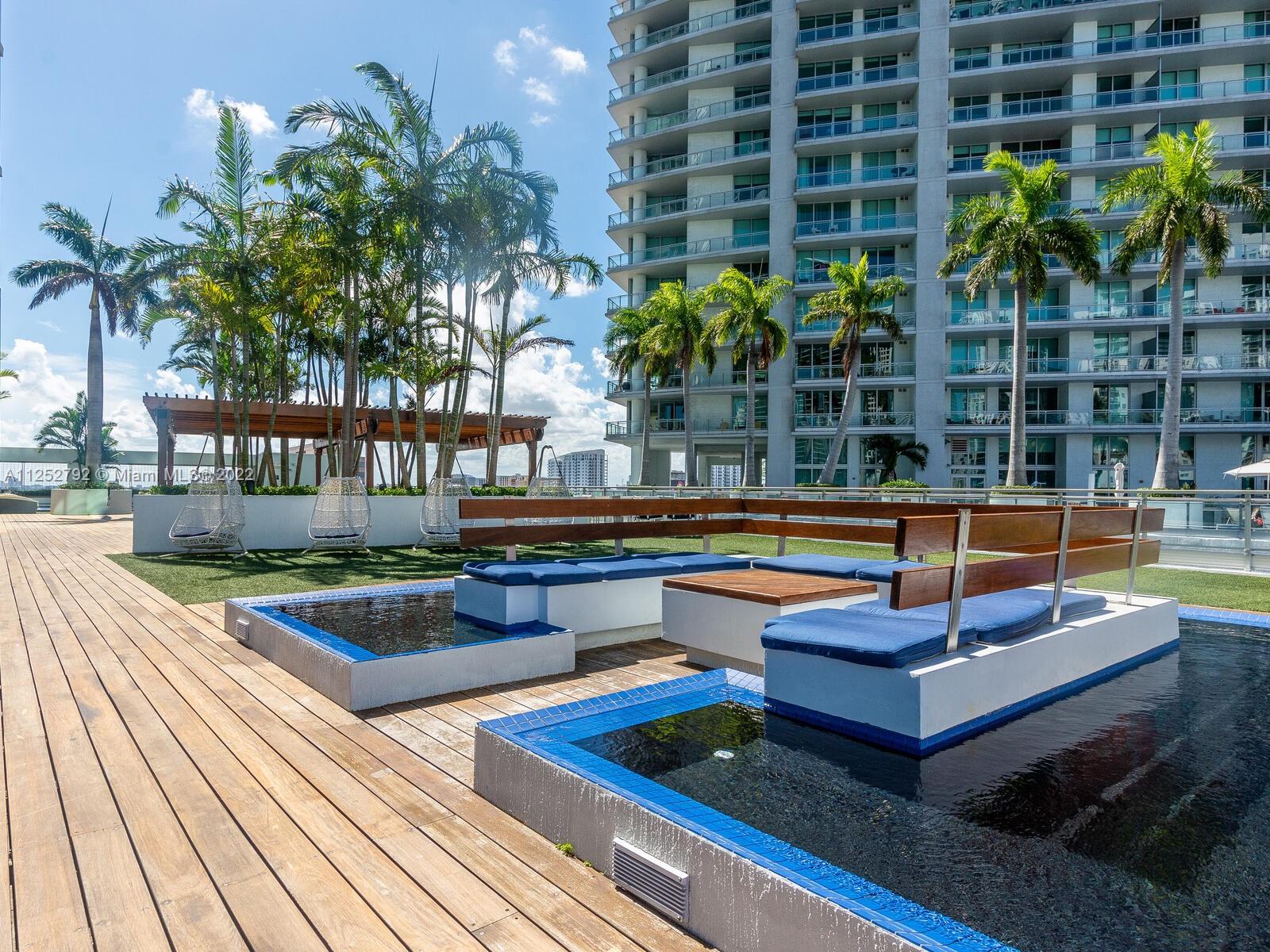 92 Southwest 3rd Street, Unit 1510 Miami, FL 33130 - Photo 76 of 90 a view of a swimming pool with a lounge chairs