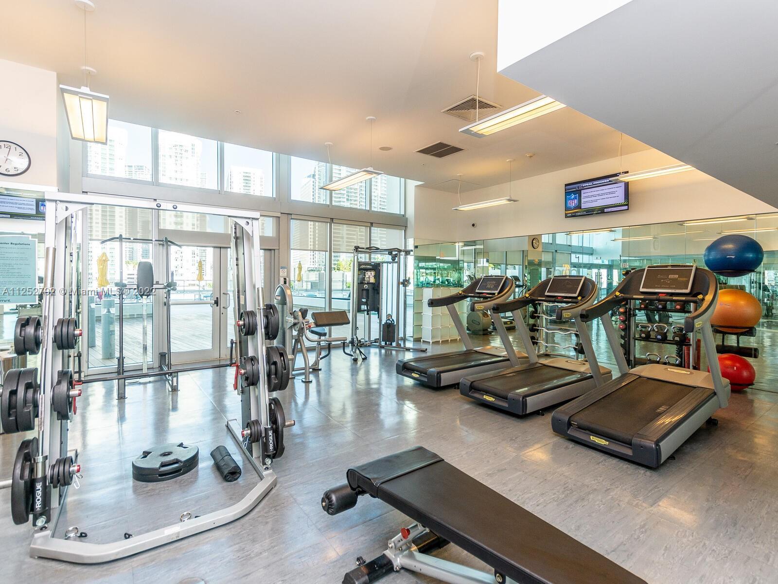 92 Southwest 3rd Street, Unit 1510 Miami, FL 33130 - Photo 82 of 90 a room with gym equipment and a large window