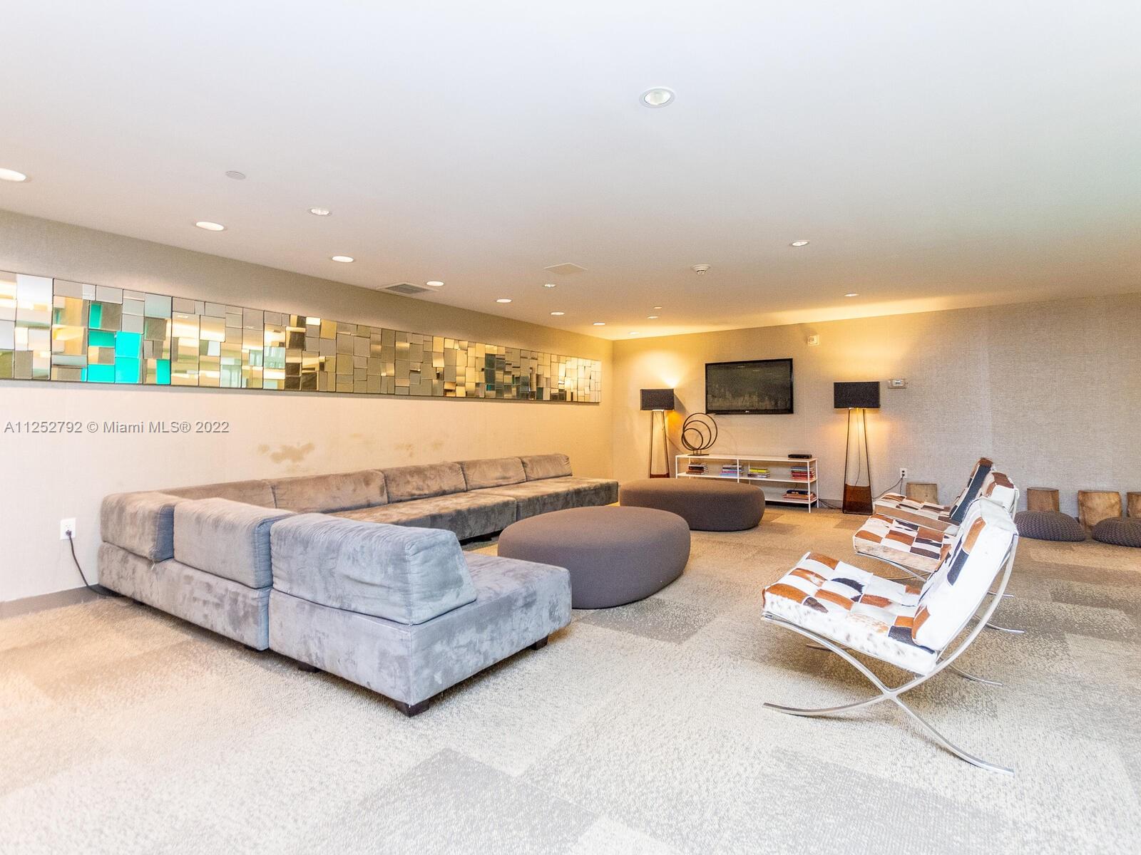 92 Southwest 3rd Street, Unit 1510 Miami, FL 33130 - Photo 84 of 90 a living room with furniture and gym equipment