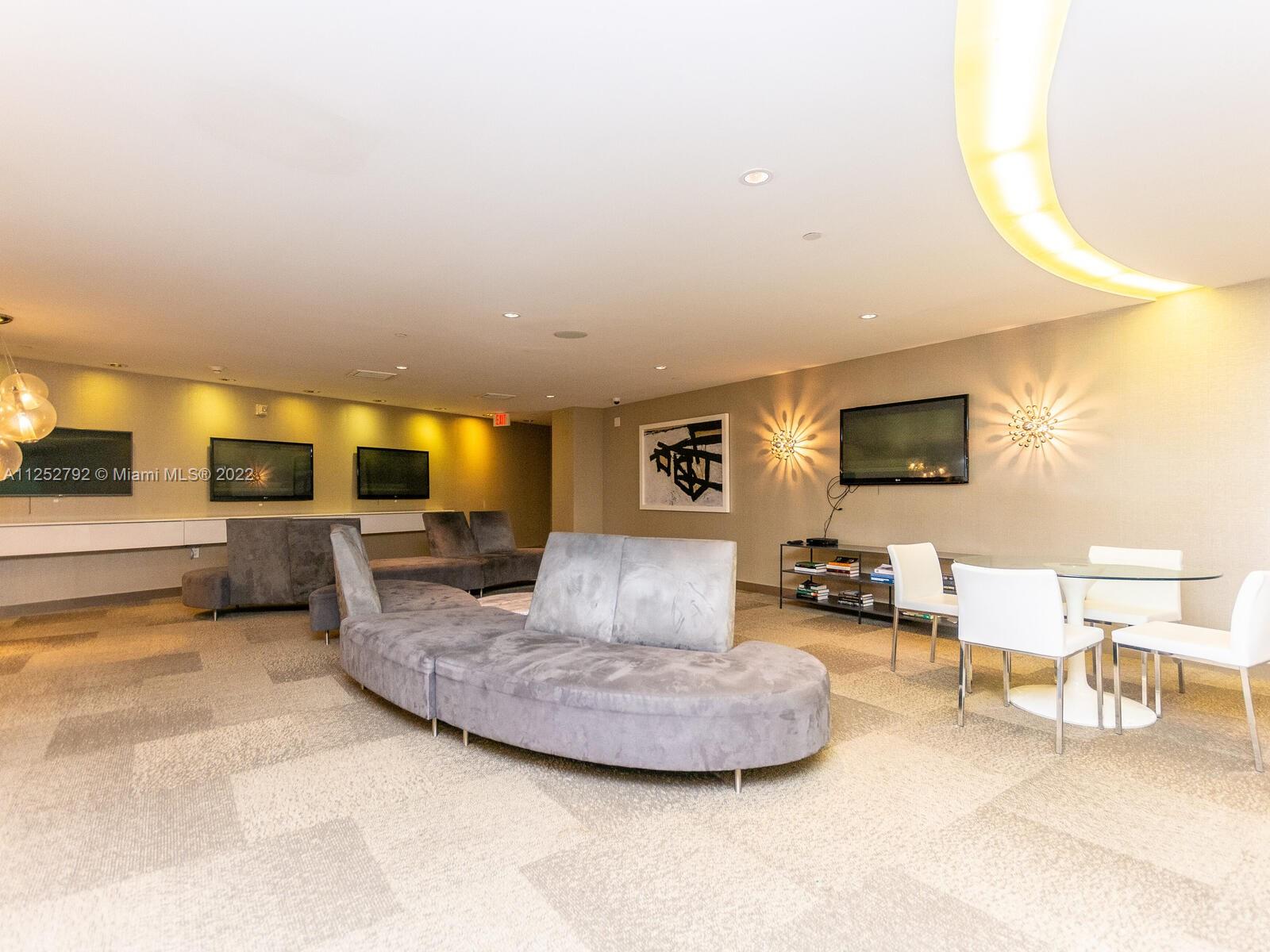 92 Southwest 3rd Street, Unit 1510 Miami, FL 33130 - Photo 89 of 90 a living room with furniture and a flat screen tv