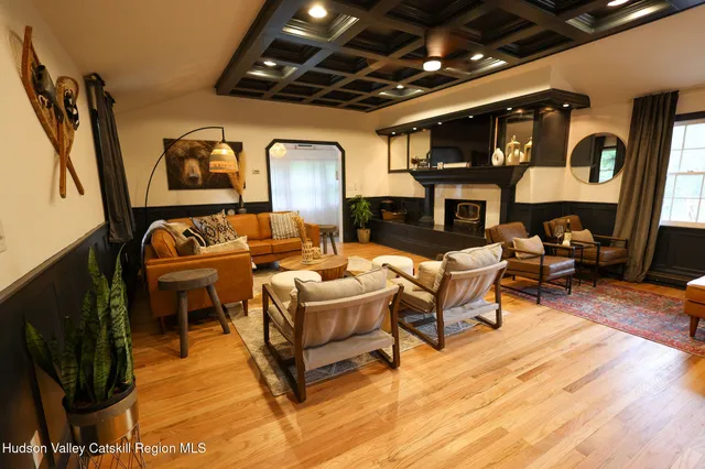 a kitchen with stainless steel appliances wooden floors dining table and chairs