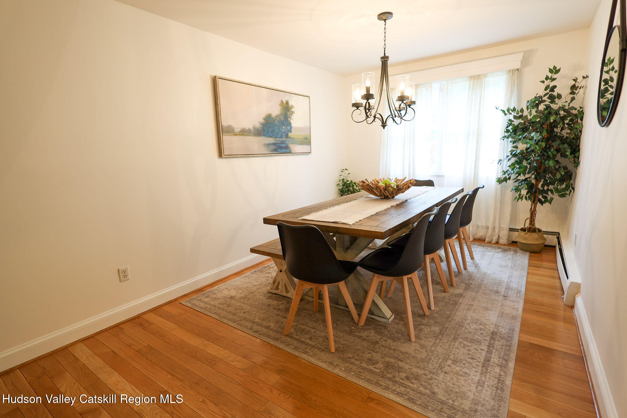 523 Mitchell Hollow Road Windham, NY 12496 - Photo 22 of 59 a view of a dining room with furniture and wooden floor