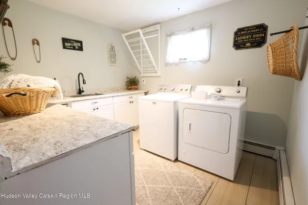 a living room with furniture a window and a flat screen tv