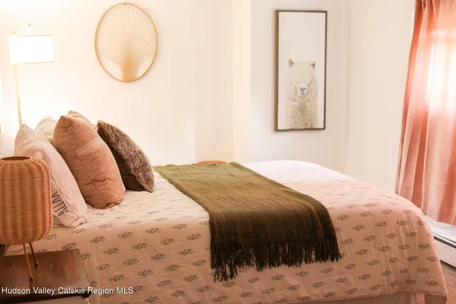 a bedroom with furniture and wooden floor