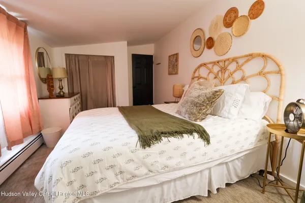 a bedroom with furniture and wooden floor