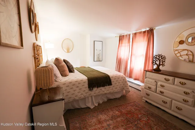 a bedroom with furniture and a window