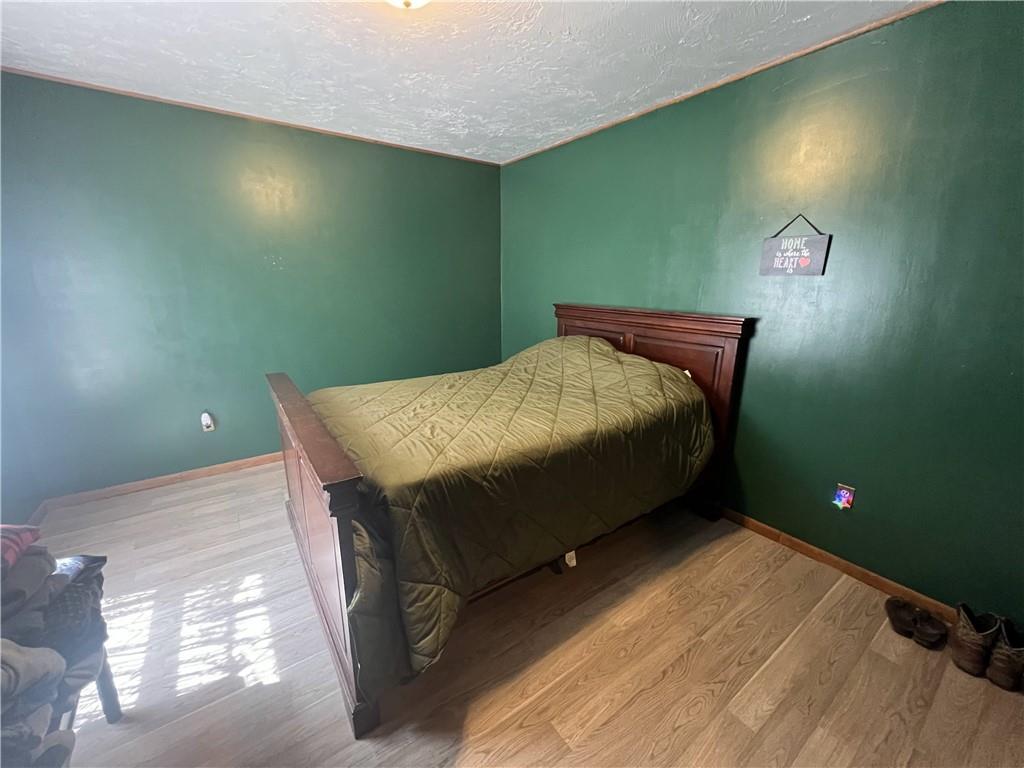 1149 School Road Apollo, PA 15613 - Photo 22 of 32 a bed sitting in a bedroom next to a bathroom