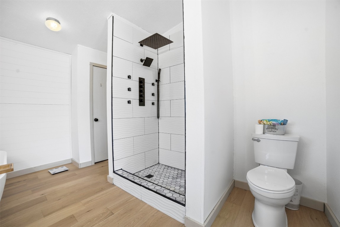 4048 Sutherland Springs Road Seguin, TX 78155 - Photo 16 of 23 a bathroom with a shower a toilet and a sink