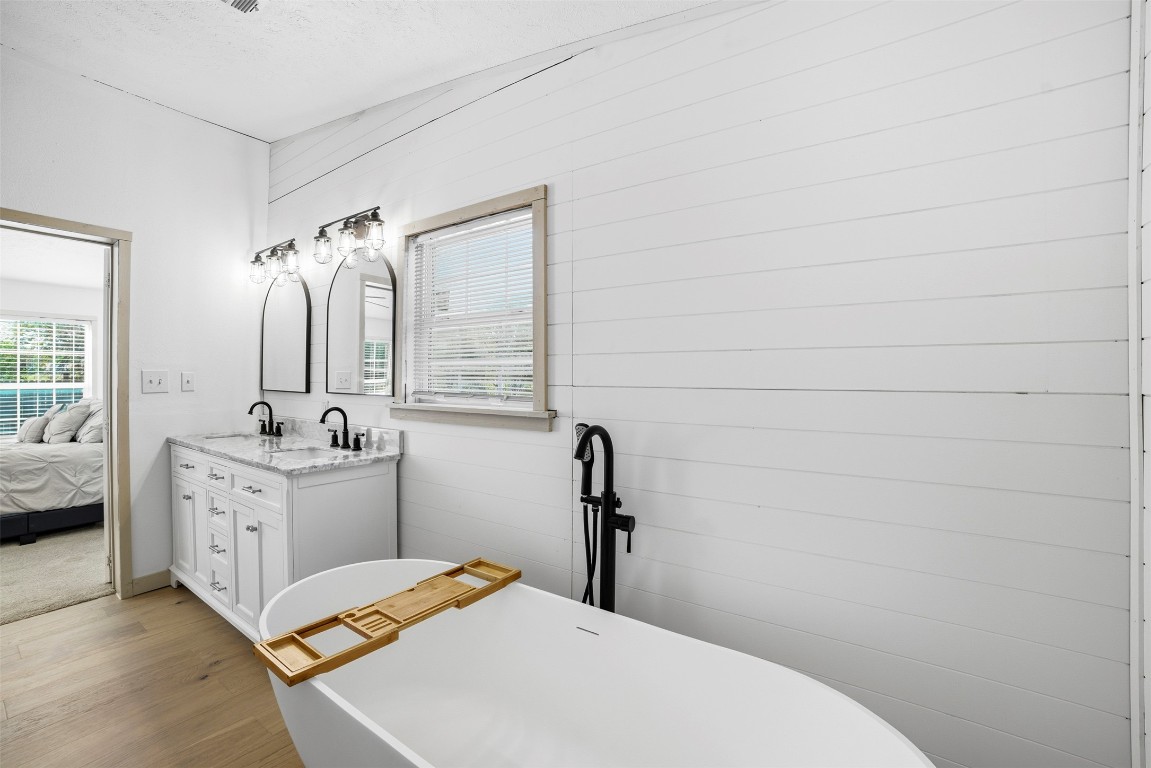 4048 Sutherland Springs Road Seguin, TX 78155 - Photo 17 of 23 a bathroom with a sink vanity granite tub and shower