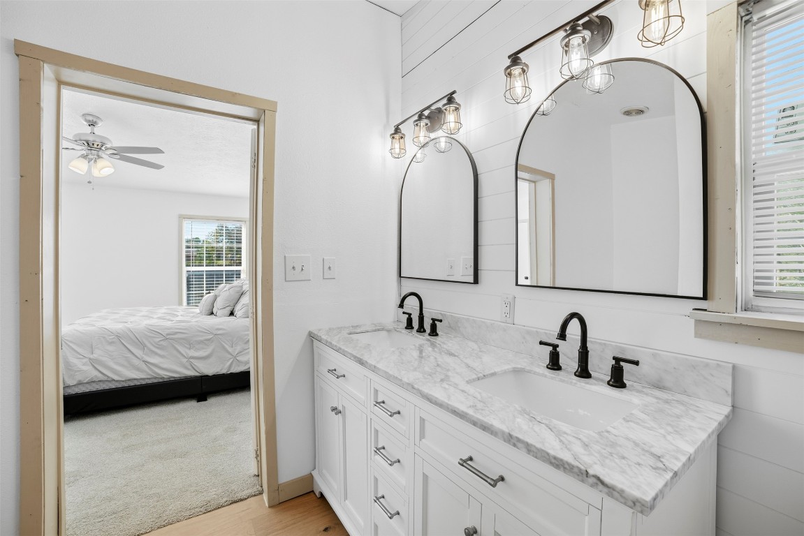 4048 Sutherland Springs Road Seguin, TX 78155 - Photo 18 of 23 a en suite bathroom with a granite countertop sink and a mirror