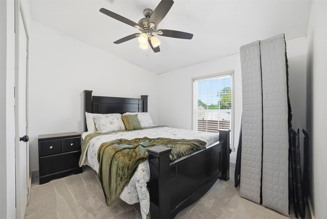 4048 Sutherland Springs Road Seguin, TX 78155 - Photo 20 of 23 a bedroom with a bed and a chandelier