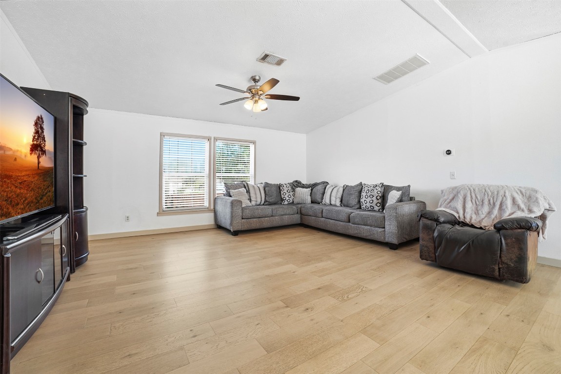 4048 Sutherland Springs Road Seguin, TX 78155 - Photo 7 of 23 a living room with furniture and a flat screen tv
