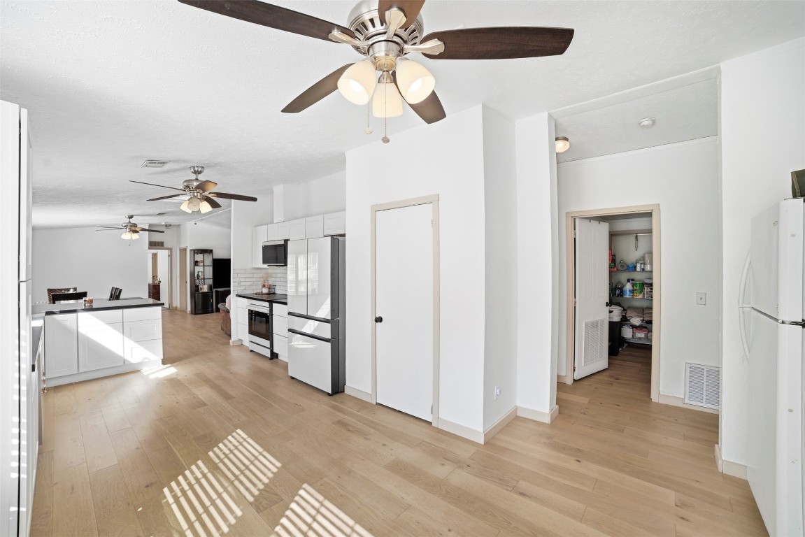4048 Sutherland Springs Road Seguin, TX 78155 - Photo 8 of 23 a view of a kitchen with refrigerator and a stove top oven