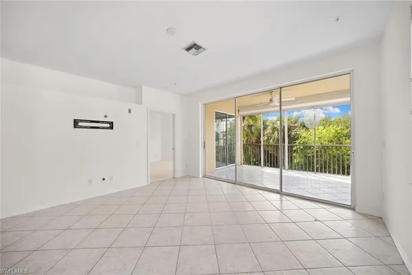 a living room with furniture and a floor to ceiling window