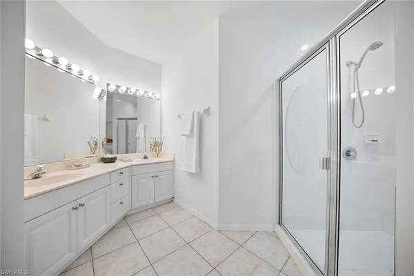 a bathroom with a granite countertop sink a mirror and a bathtub