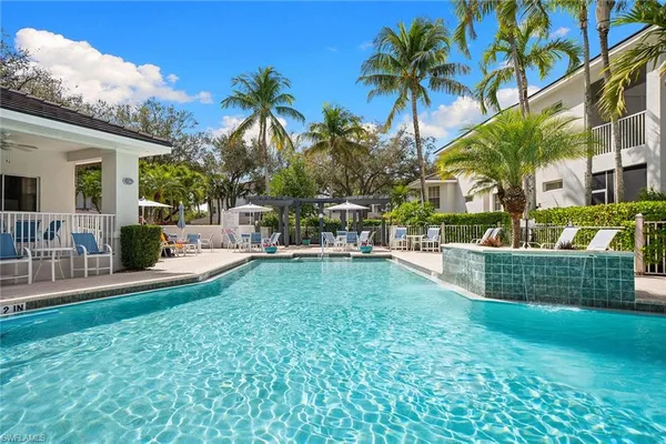 a view of a house with swimming pool and sitting area