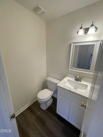 a bathroom with a sink toilet and mirror