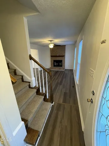a view of entryway and hall with wooden floor