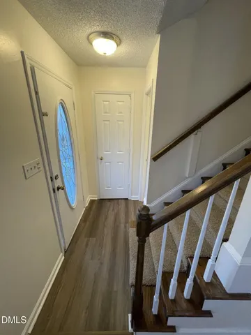 a view of front door with wooden floor