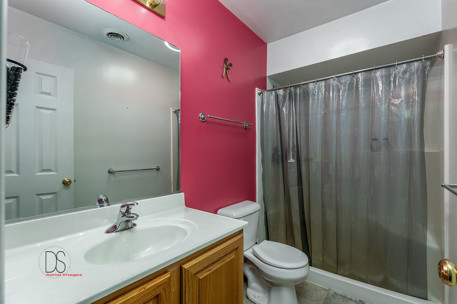 2064 North 3569th Road Serena, IL 60549 - Photo 23 of 36 a bathroom with a sink a toilet a mirror and shower curtain