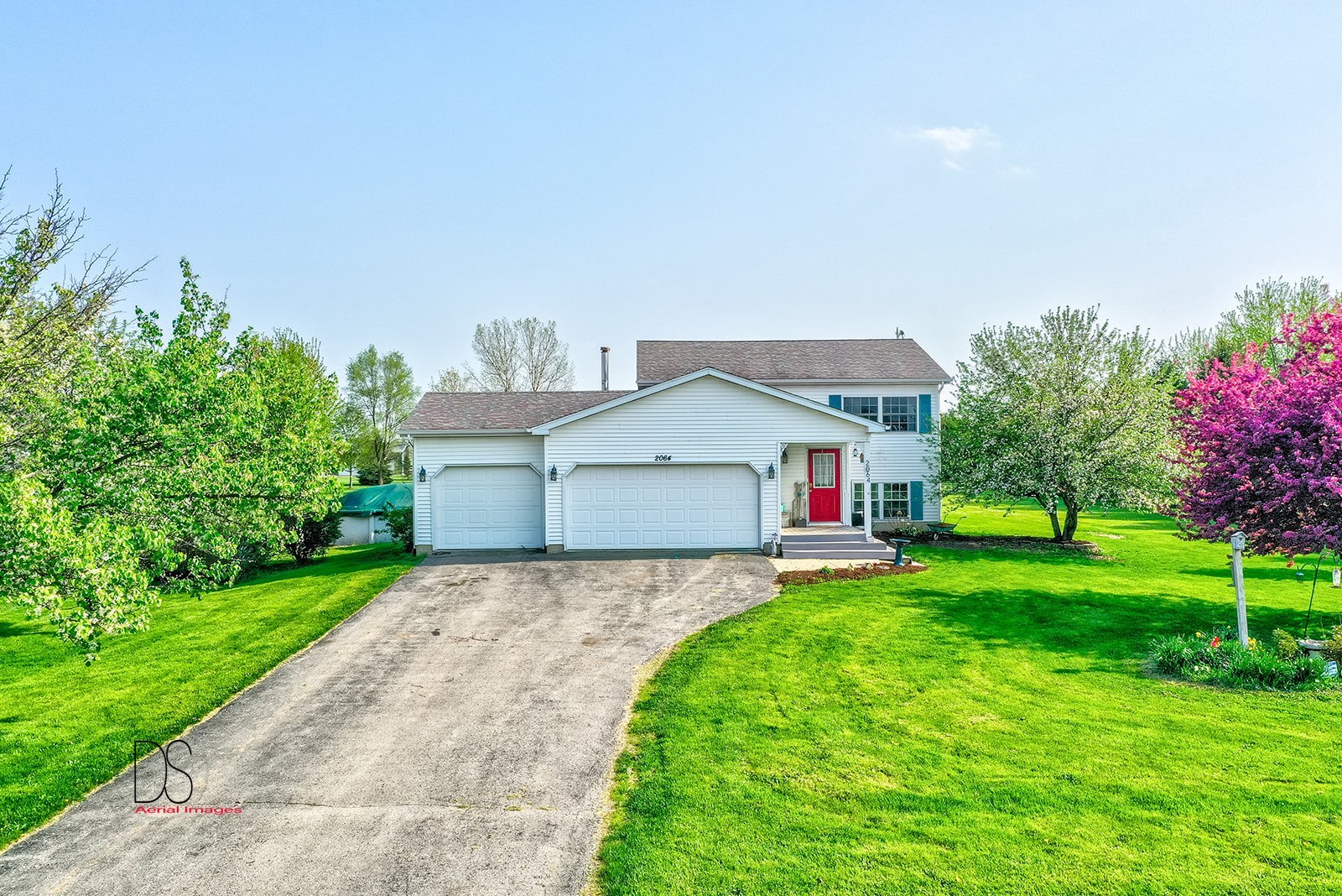 2064 North 3569th Road Serena, IL 60549 - Photo 4 of 36 a front view of a house with a yard and garage