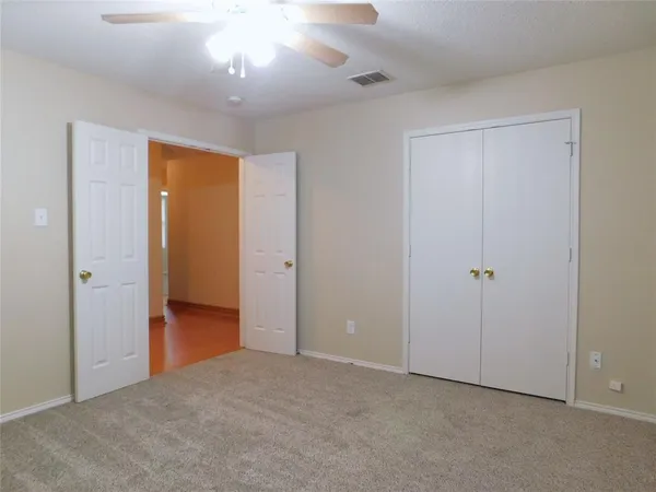 a view of an empty room and closet area