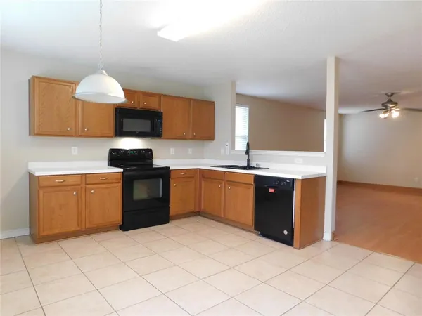 a kitchen with a sink cabinets and a stove
