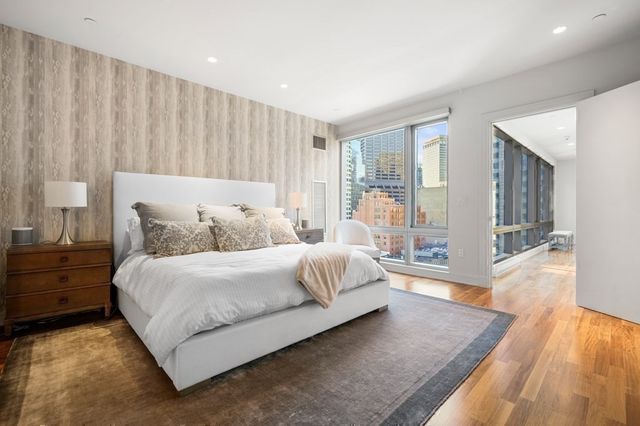 a spacious bedroom with a large bed and a couch