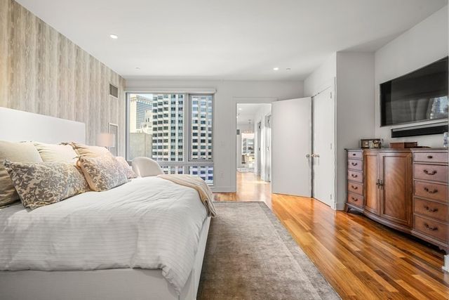 a bedroom with a bed and a television