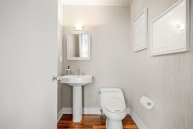 a bathroom with a toilet sink and mirror