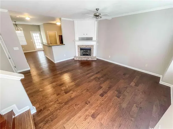 wooden floor in an empty room with a fireplace