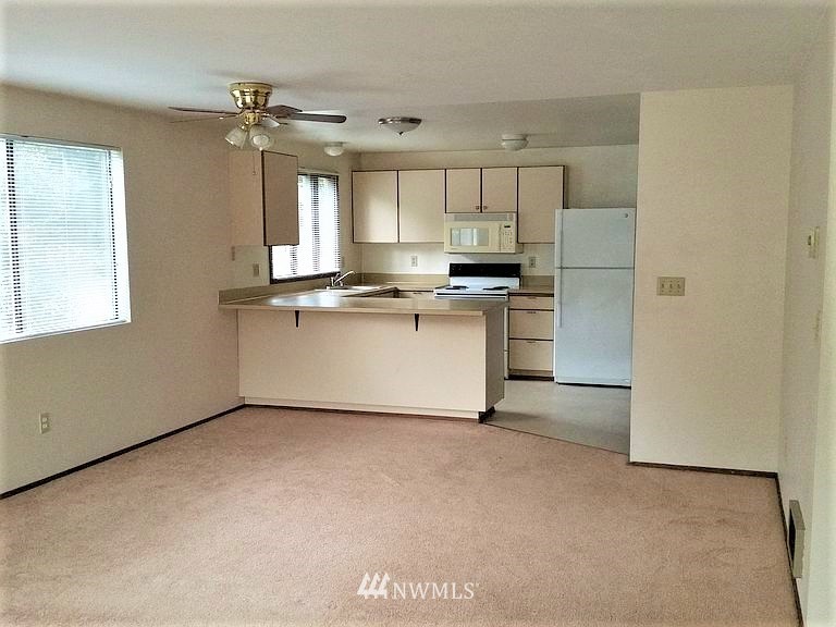 23523 Edmonds Way Edmonds, WA 98026 - Photo 4 of 7 a kitchen with stainless steel appliances a sink stove and cabinets