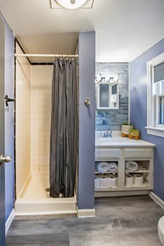 a bathroom with a sink a mirror and a shower